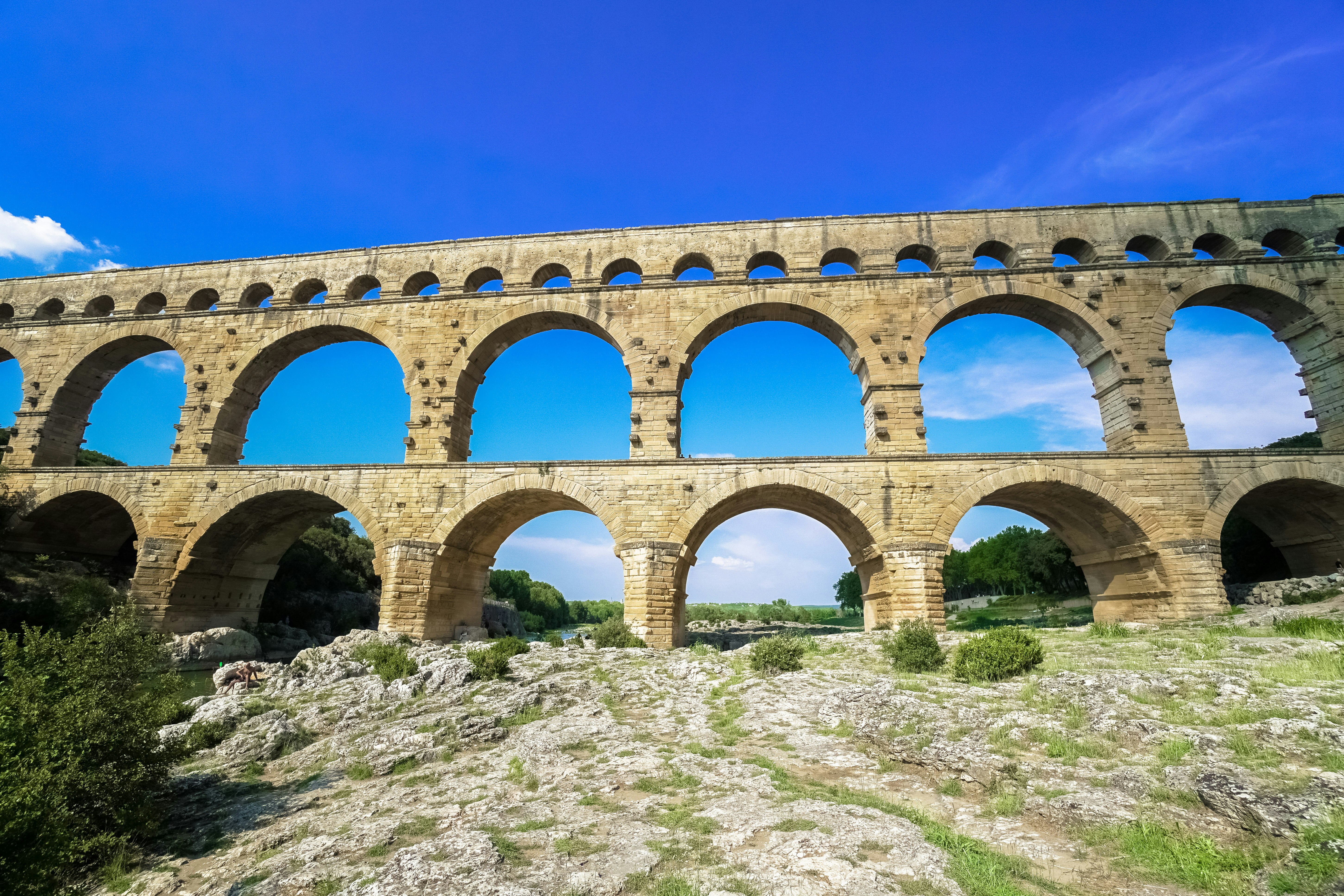 brown concrete bridge under blue sky during daytime